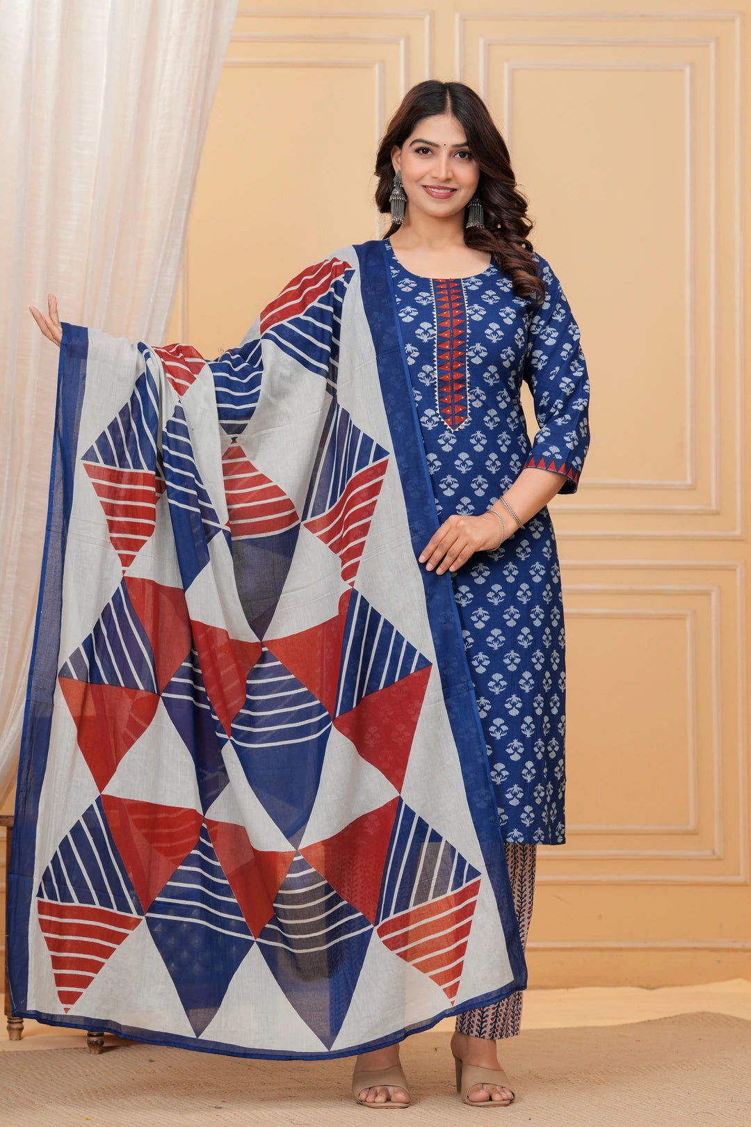 A woman wearing a navy blue handblock printed cotton kurta with a large geometric print dupatta in red, blue, and white.