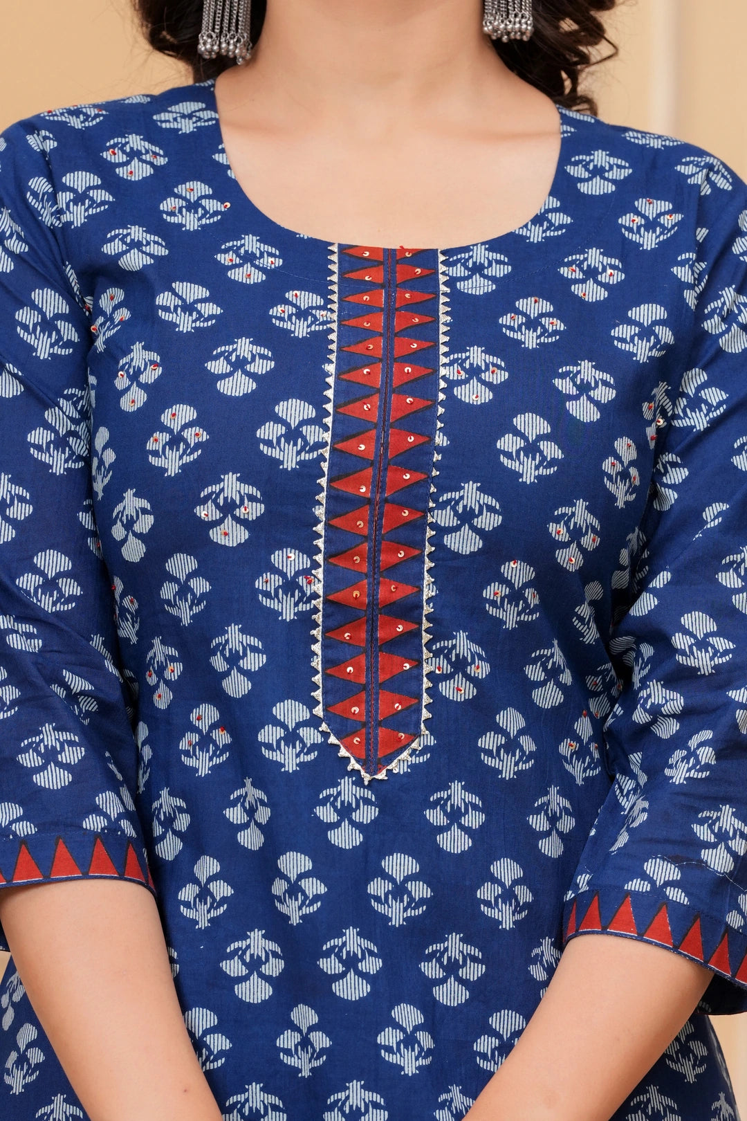A woman wearing a navy blue handblock printed cotton kurta with a large geometric print dupatta in red, blue, and white.
