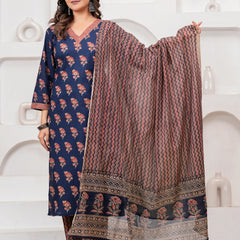 Woman wearing a navy blue cotton kurta with red floral handblock prints, matching zigzag patterned trousers, and a coordinating printed dupatta.