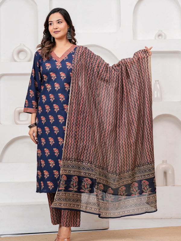 Woman wearing a navy blue cotton kurta with red floral handblock prints, matching zigzag patterned trousers, and a coordinating printed dupatta.