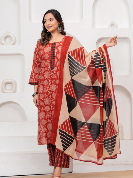 Woman in a Rust Red floral handblock printed cotton kurta set with black and beige geometric patterned dupatta and chevron pants.
