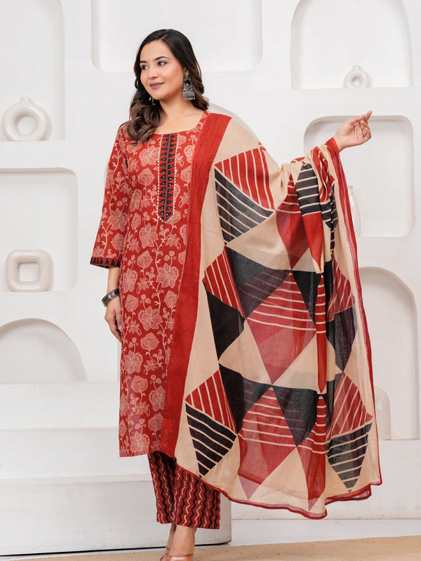 Woman in a Rust Red floral handblock printed cotton kurta set with black and beige geometric patterned dupatta and chevron pants.