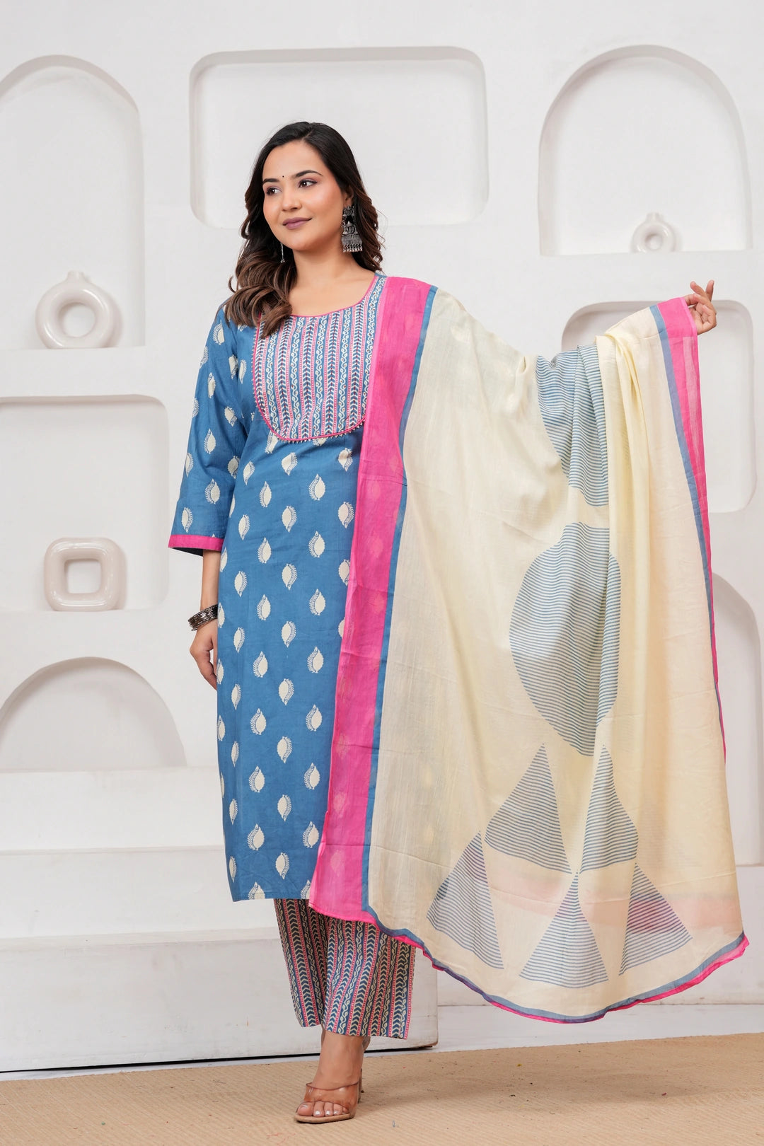 Woman in a blue Jaipur handblock printed cotton kurta with leaf motifs and a designer off-white dupatta with pink borders.