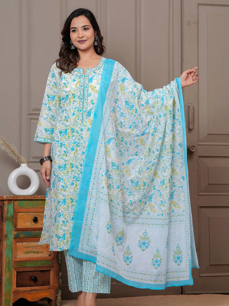 A woman posing in a white cotton kurta set featuring blue and yellow handblock floral prints with a matching dupatta and pants.