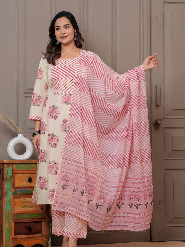 Woman in a cream-colored straight kurta with pink handblock floral prints and a chevron patterned pink leheriya dupatta.