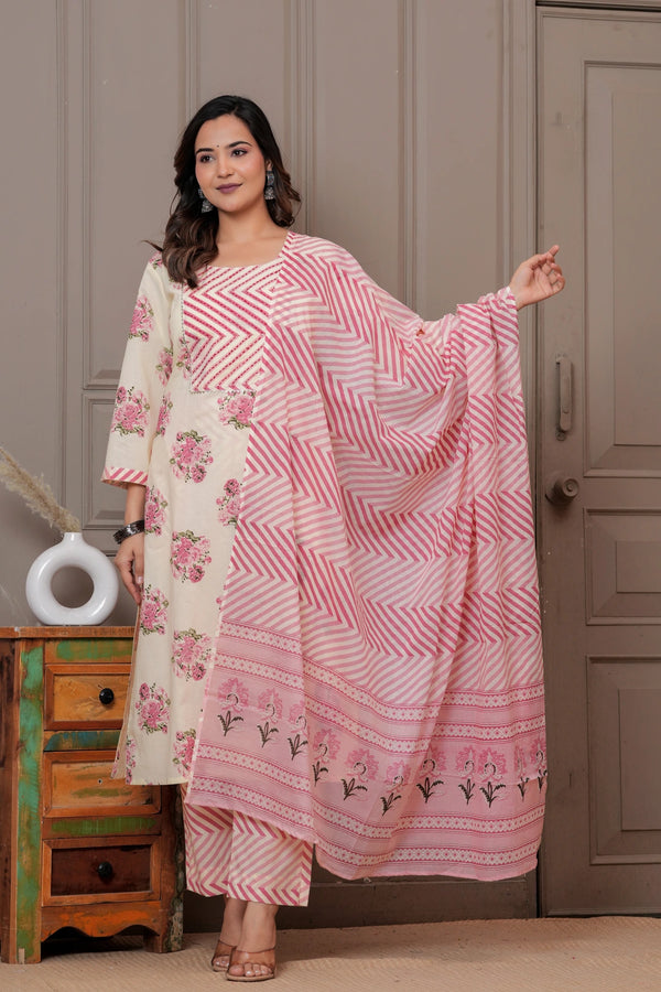 Woman in a cream-colored straight kurta with pink handblock floral prints and a chevron patterned pink leheriya dupatta.