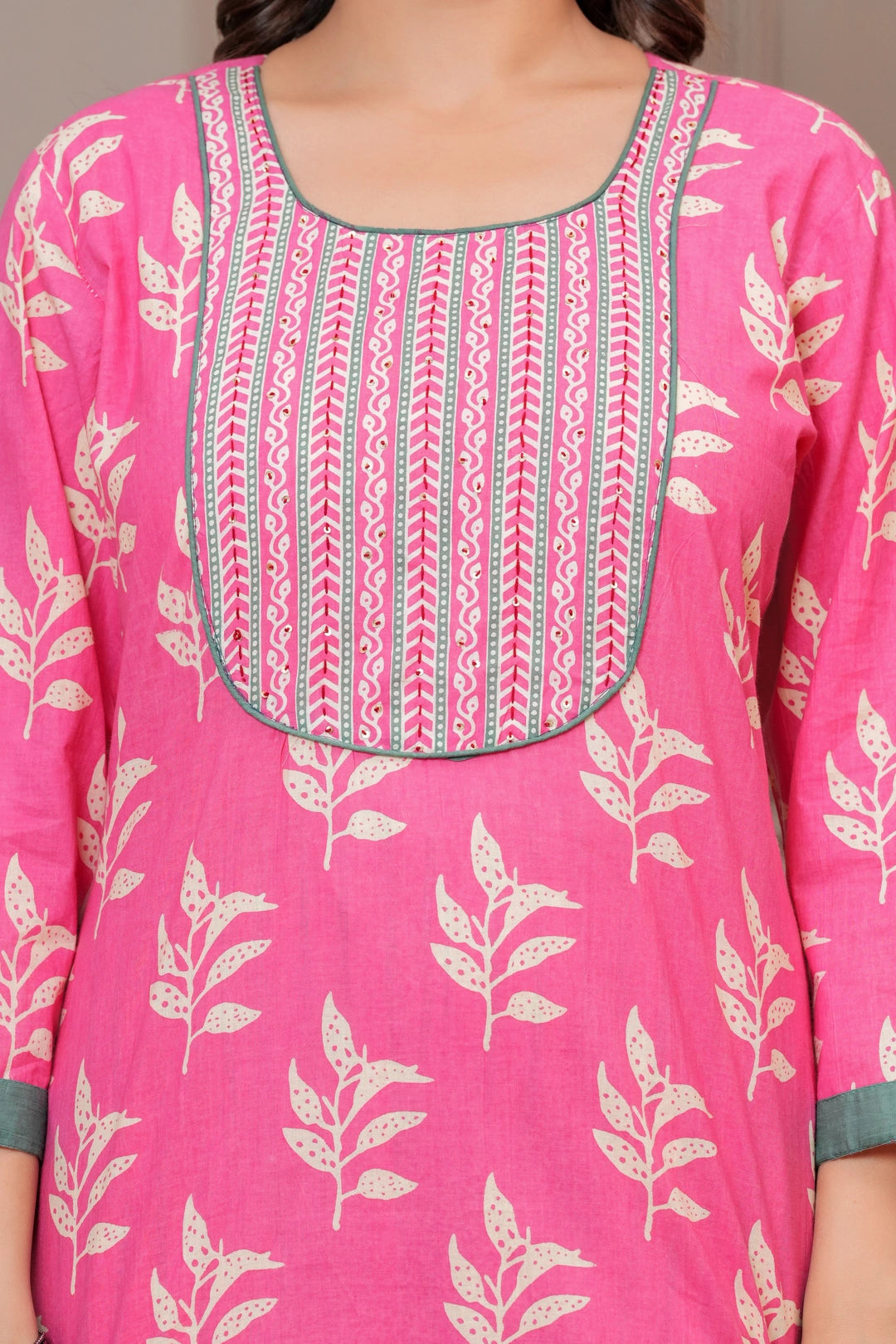 Women wearing a pink floral handblock printed kurta with matching patterned pants and a cream-colored printed dupatta with green borders.