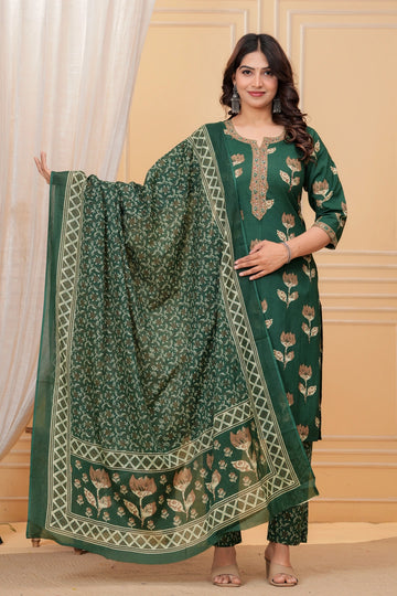 Model posing in a dark green handblock printed straight kurta with an embroidered neck, matching printed pants, and a heavily bordered Chanderi dupatta.
