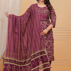 Woman wearing a purple handblock printed cotton kurta set with a chevron pattern dupatta and matching straight pants in a studio setting.