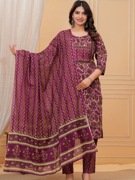 Woman wearing a purple handblock printed cotton kurta set with a chevron pattern dupatta and matching straight pants in a studio setting.