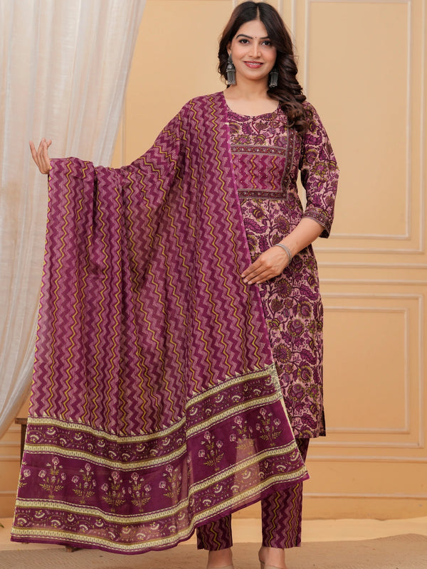 Woman wearing a purple handblock printed cotton kurta set with a chevron pattern dupatta and matching straight pants in a studio setting.