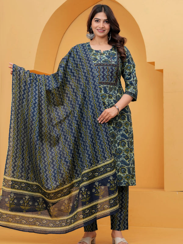 A woman posing in a navy blue handblock printed cotton kurta with floral patterns, featuring matching zigzag pants and a printed dupatta.