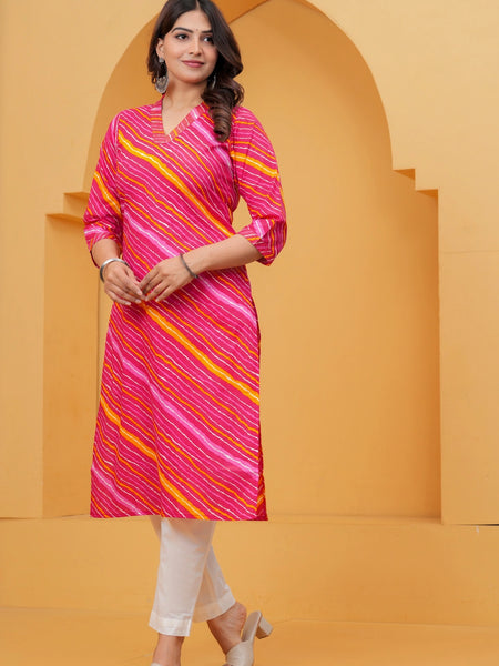 Woman wearing a bright pink Leheriya printed cotton kurta with orange and white stripes, featuring a V-neck and three-quarter sleeves.
