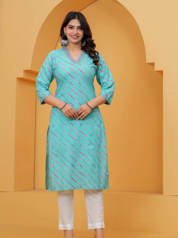 A woman wearing a vibrant turquoise blue straight-cut cotton kurta featuring pink and white diagonal Leheriya stripes, paired with white pants.
