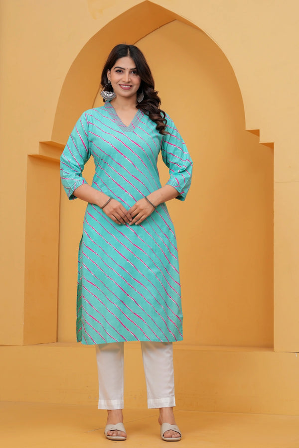 A woman wearing a vibrant turquoise blue straight-cut cotton kurta featuring pink and white diagonal Leheriya stripes, paired with white pants.