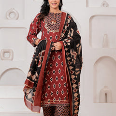 Woman wearing a maroon and black Ikat print cotton kurta set with a matching black dupatta and chevron trousers.