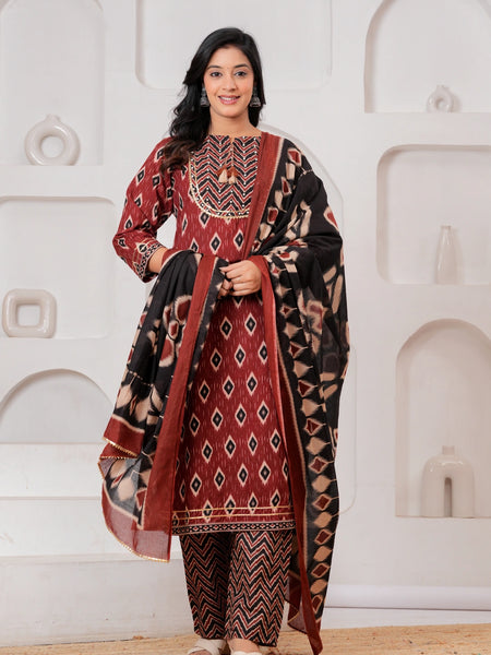 Woman wearing a maroon and black Ikat print cotton kurta set with a matching black dupatta and chevron trousers.